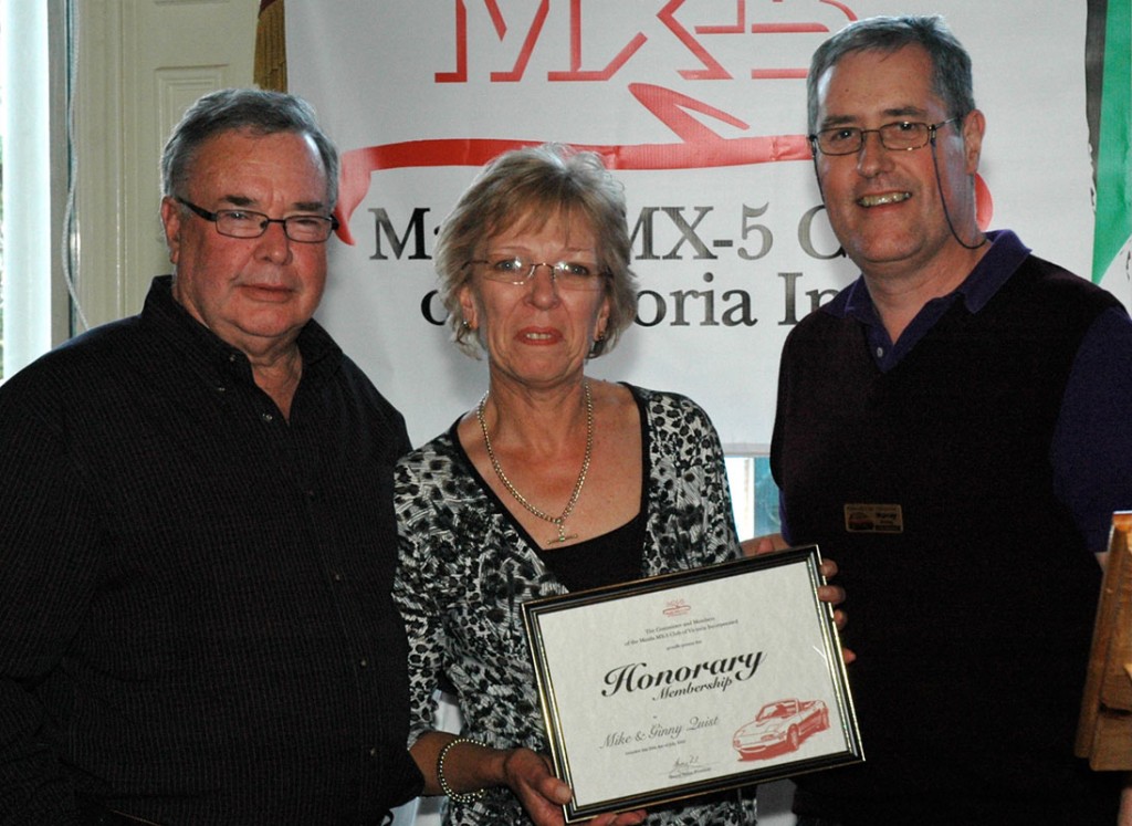 RIP Quisty: Former Mazda PR manager Mike Quist (left) and wife Ginny receive life memberships of the Mazda MX-5 Club of Victoria from the club's Murray Finlay.